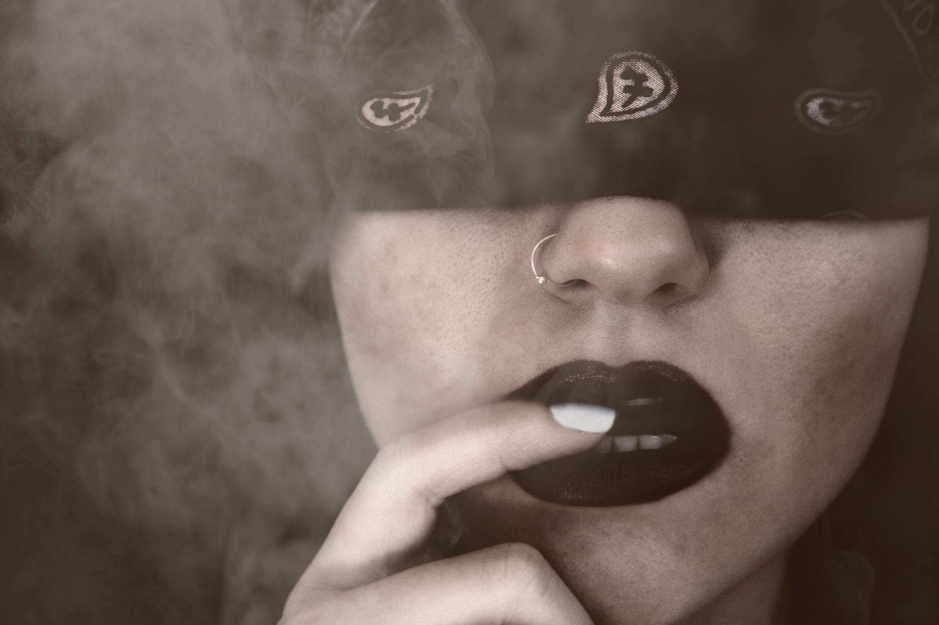 blindfolded woman with finger on lips grayscale portrait